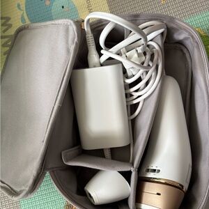 Braun hair removalWhite and Gold Handheld Personal Care Device with Travel Pouch